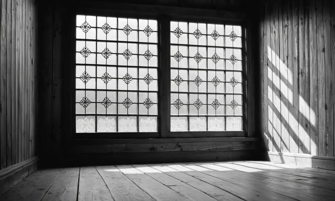 A captivating black and white photograph showcases a vintage window frame adorned with delicate lace curtains, casting beautiful shadows on a weathered wooden floor, evoking a timeless and nostalgic atmosphere.