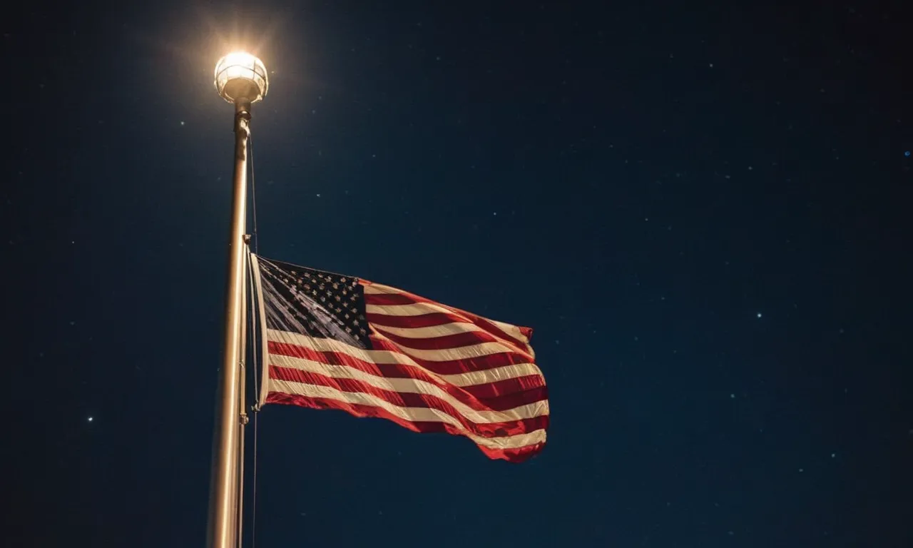 A stunning image showcasing a majestic telescoping flagpole adorned with a brilliant solar light, gently illuminating the night sky and proudly displaying the waving national flag.