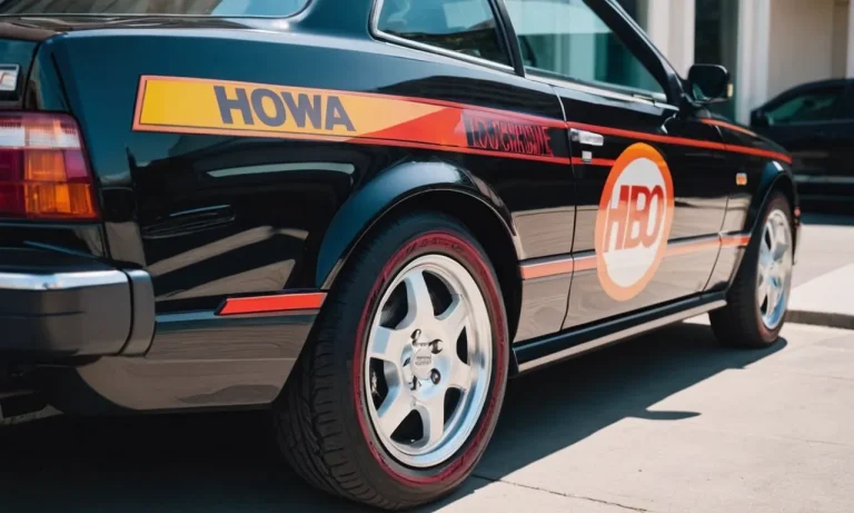 A close-up shot of a sleek, black car showcasing vibrant and precisely cut car decals, made with the best permanent vinyl, adding a touch of personal style and durability to the vehicle.