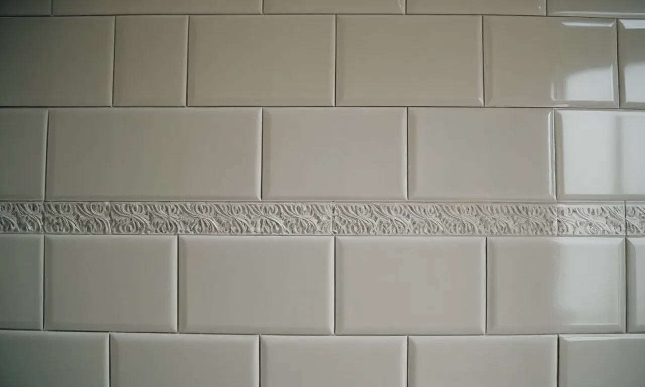 A close-up photo capturing a pristine white caulk line, skillfully applied between tiles in a bathroom, acting as a barrier to prevent mold growth and ensuring a hygienic environment.