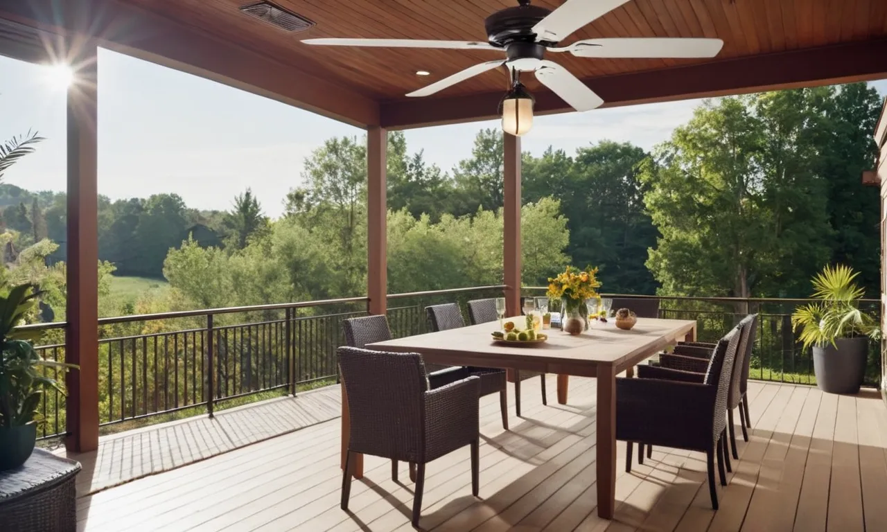 A captivating photo showcasing a beautifully decorated outdoor patio, featuring a sleek and modern ceiling fan without lights, effortlessly blending with the natural surroundings and providing a cool breeze on a sunny day.