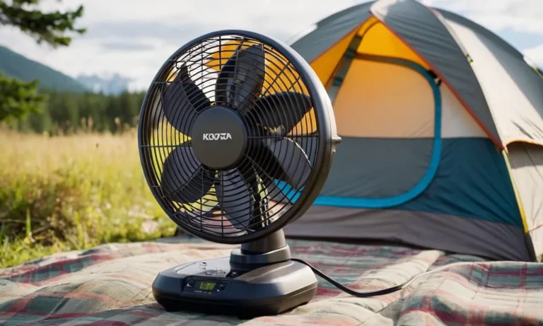 A close-up shot of a compact and portable battery-operated fan perched on a tent's mesh, providing a refreshing breeze during a camping trip.