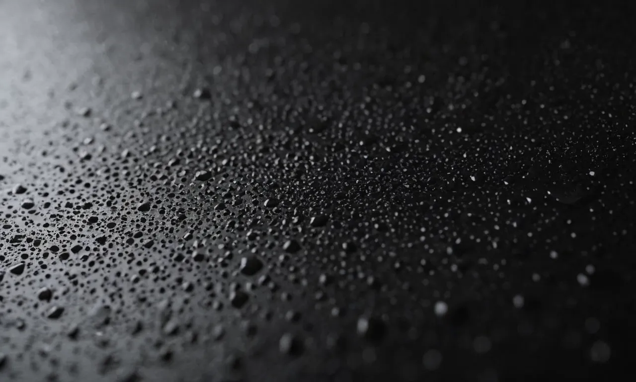 A close-up shot of a metal surface coated with the finest black spray paint, showcasing its smooth finish and highlighting its durability and elegance.