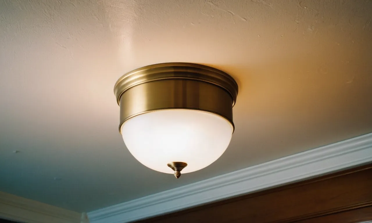 A close-up photo capturing a sleek, flush mount light fixture with a frosted glass shade, casting a soft and warm glow on a low ceiling, illuminating the space beautifully.