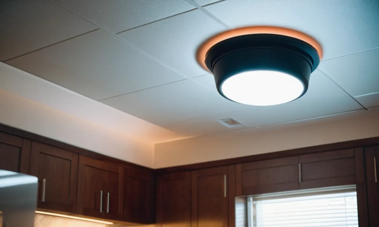 A snapshot of a modern bathroom ceiling with a sleek exhaust fan featuring a built-in light and a Bluetooth speaker, seamlessly blending functionality, convenience, and style.