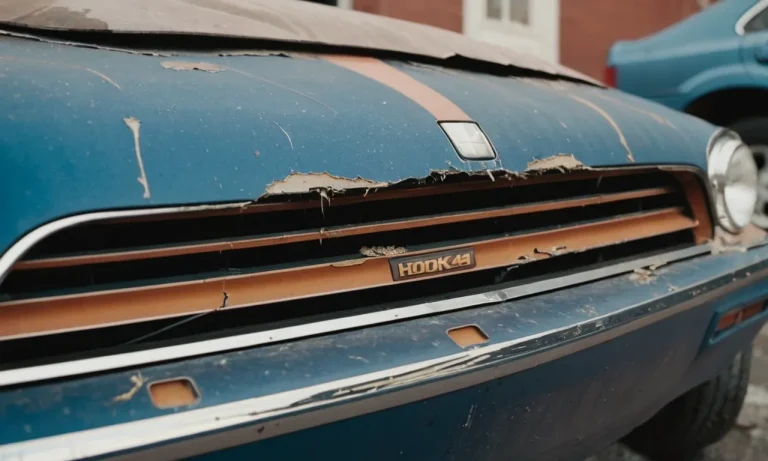 A close-up photo capturing the damaged area on a car's exterior, showing scraped paint with visible scratches and the extent of the damage.
