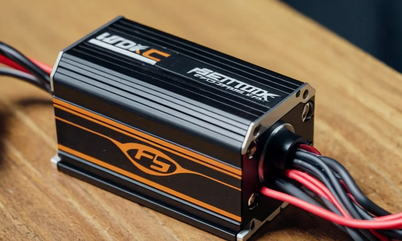 A close-up shot of a sleek, high-performance 1/10 scale brushless motor ESC combo, capturing its intricate wiring, compact design, and powerful performance potential.