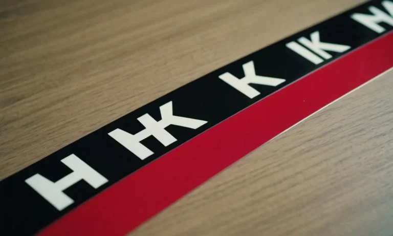 A close-up shot capturing the precision of a transfer tape perfectly aligning permanent vinyl letters onto a smooth surface, showcasing its remarkable adhesive quality and ease of use.