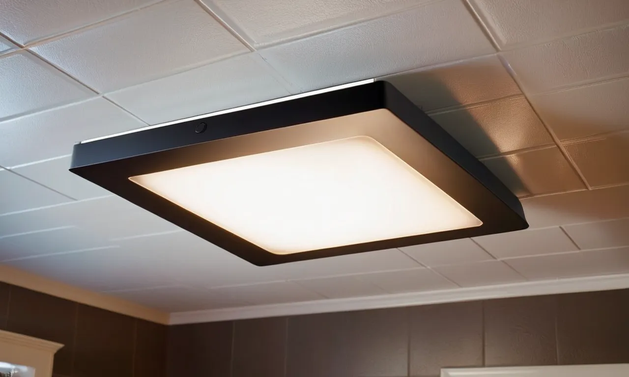 A close-up photo showcasing a sleek, modern bathroom exhaust fan with a built-in light fixture, illuminating the space and providing optimal ventilation.