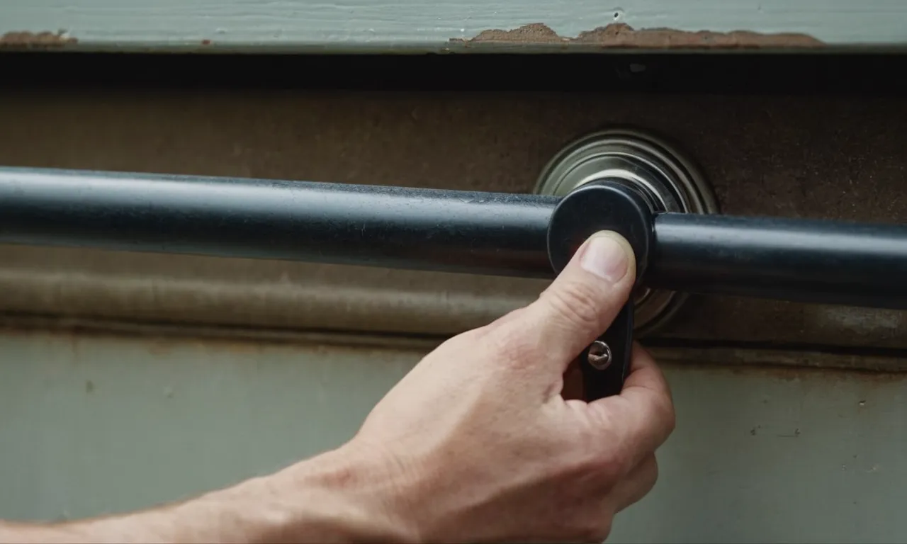 A close-up shot capturing the hand of a person firmly grasping a garage door handle, demonstrating the process of manually locking the garage door.