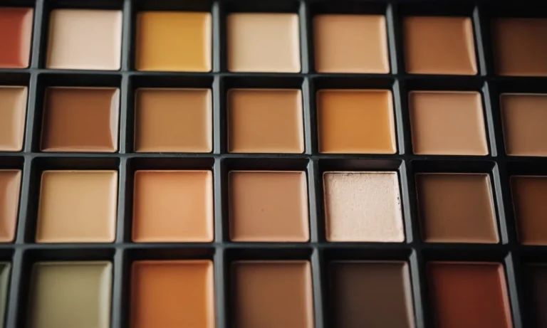 A close-up photograph capturing a palette filled with warm, earthy tones of paint, resembling the colors of a sun-kissed tan.