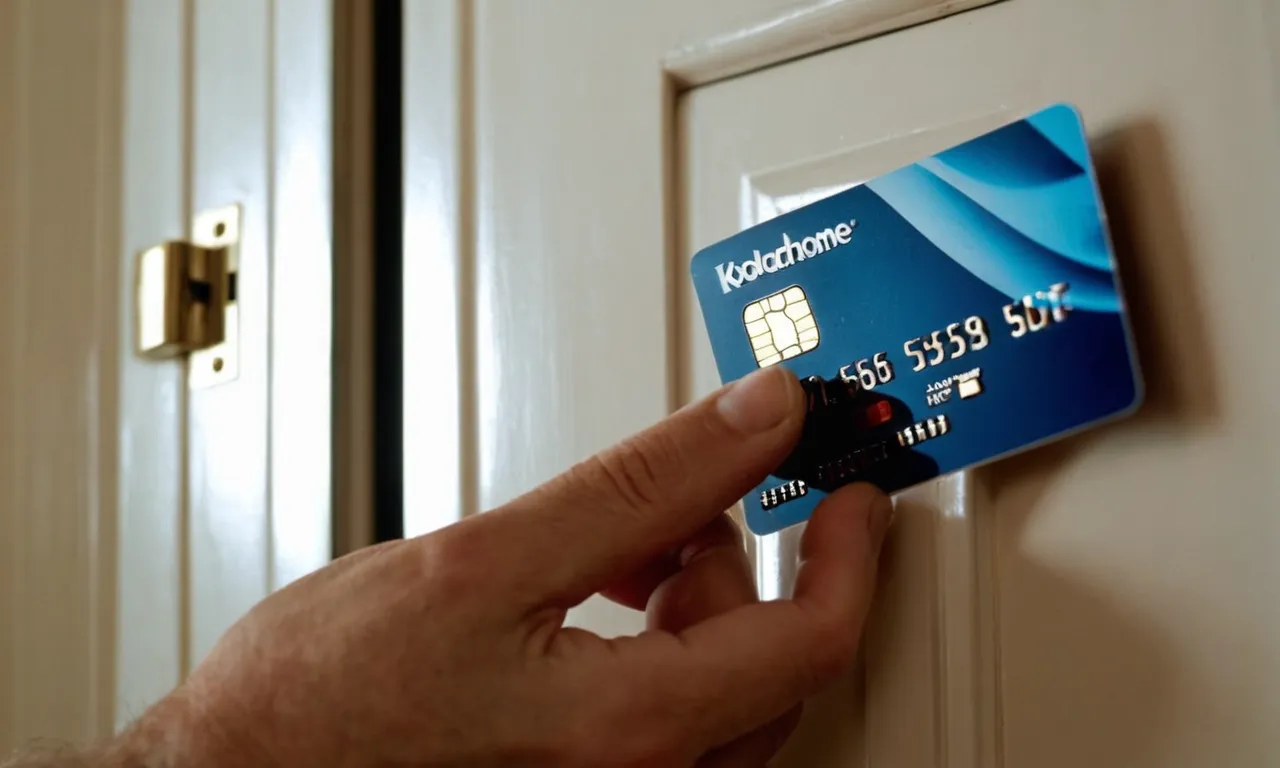A close-up shot of a hand skillfully using a credit card to slide it between the door frame and the latch, demonstrating a clever technique for opening a door without a knob.