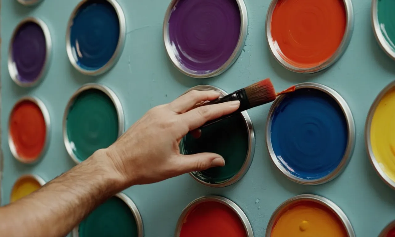 A close-up photograph capturing an artist's hand gracefully applying vibrant strokes of paint onto a wall, skillfully forming perfect circles that blend harmoniously with the surrounding colors.