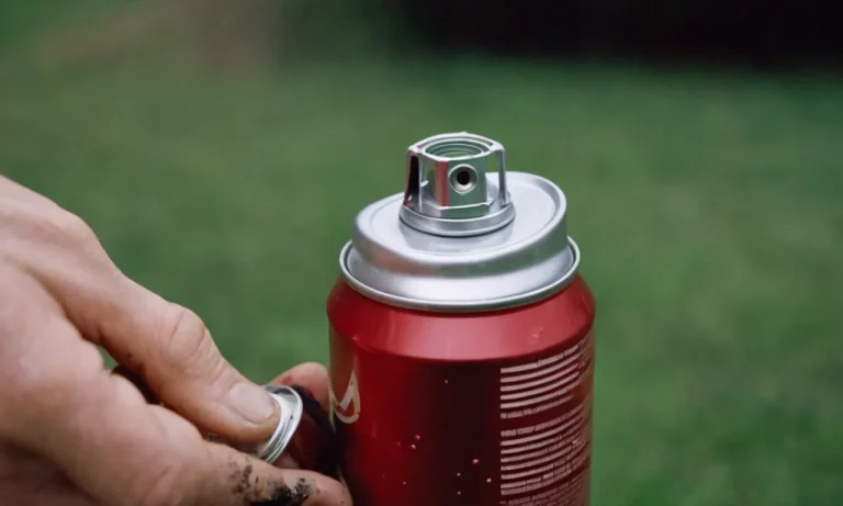 A close-up shot capturing a frustrated hand holding a brand new spray paint can, with the nozzle clogged, paint drips forming on the fingers, highlighting the struggle to make it spray.