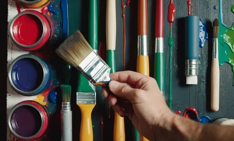 A painting depicting a hand holding a paintbrush, surrounded by vibrant acrylic paint tubes, with a wall in the background waiting to be transformed into a colorful masterpiece.