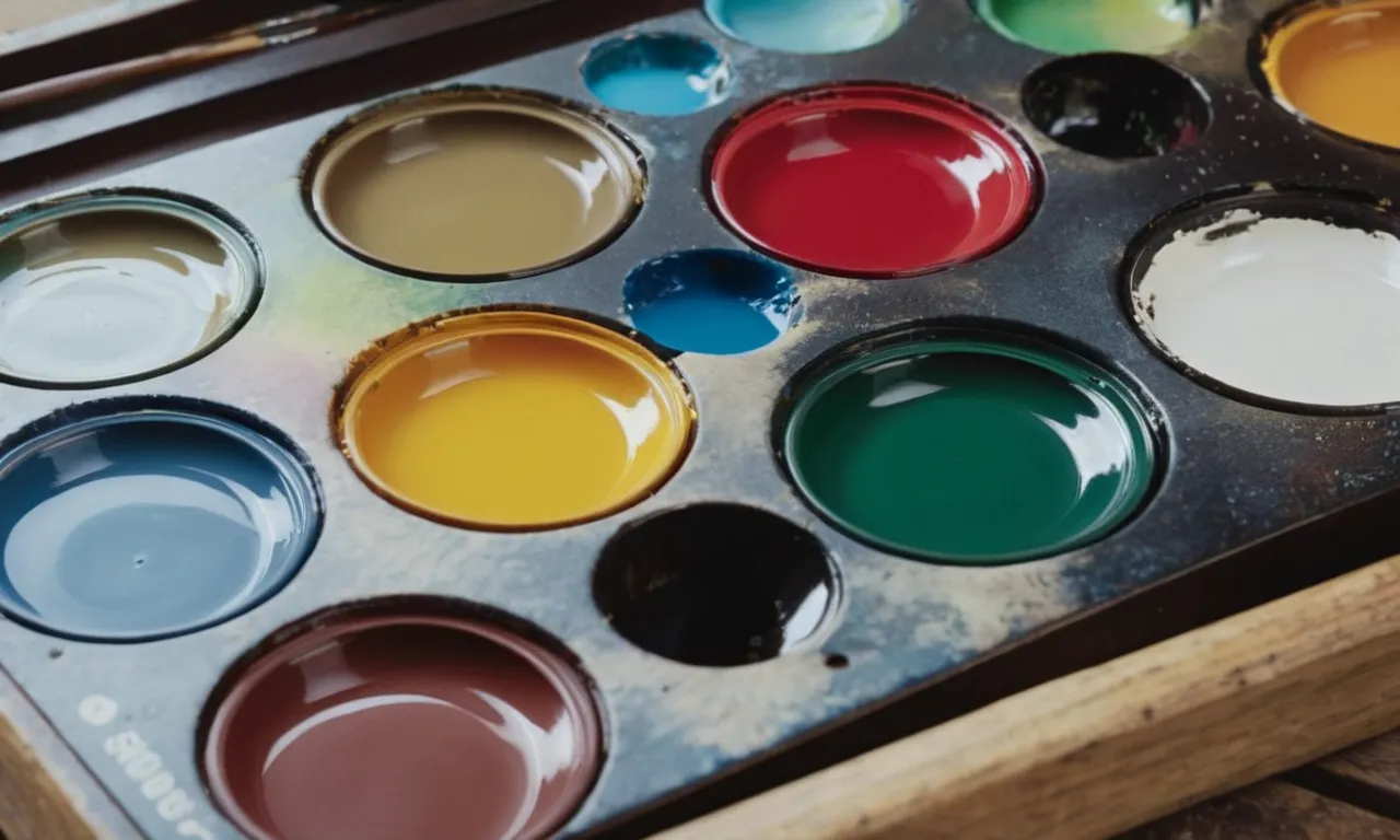 A close-up photo of Bob Ross's paint palette showcases a vibrant array of oil paint colors, revealing his signature technique and the artistic tools he used to create his iconic landscapes.